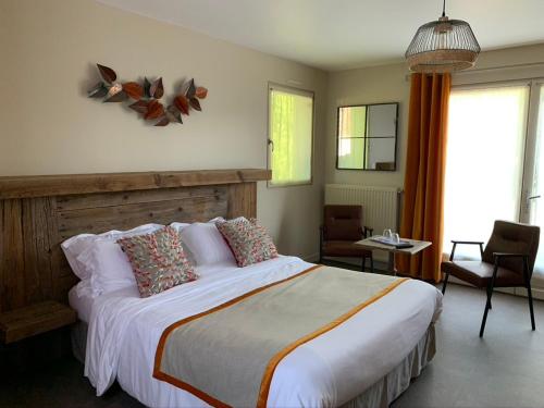 a bedroom with a large bed in a room at Le Clos du miroir in Courset