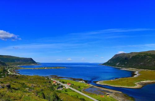 an aerial view of a river with mountains and the ocean at Rivdnji Holiday Home Smørfjord in Russenes