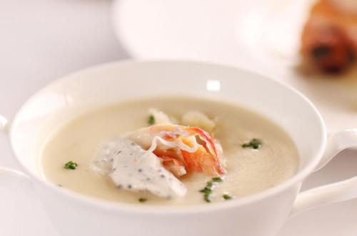 a bowl of soup with a piece of shrimp in it at Marco Polo Hongkong Hotel in Hong Kong