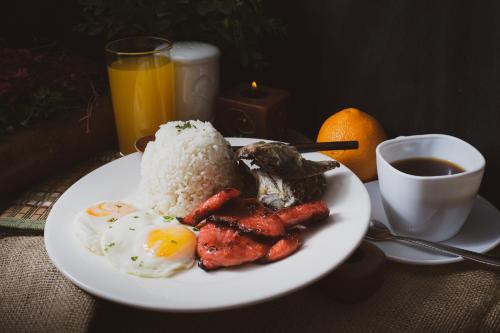 a plate of food with eggs and meat and rice at Alicia Apartelle in Cebu City