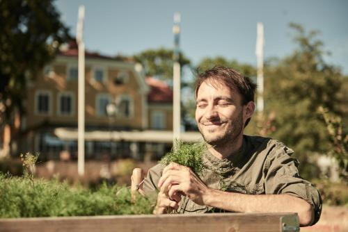 a man sitting on a bench with a beard at Knistad Herrgård in Skövde