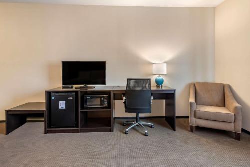 a room with a desk with a television and a chair at Sleep Inn & Suites Moab near Arches National Park in Moab