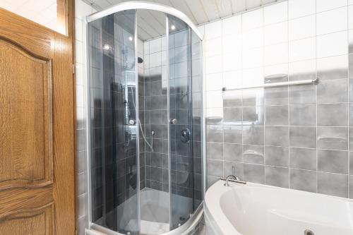 a bathroom with a shower and a bath tub at Hotel Porta Nigra in Trier