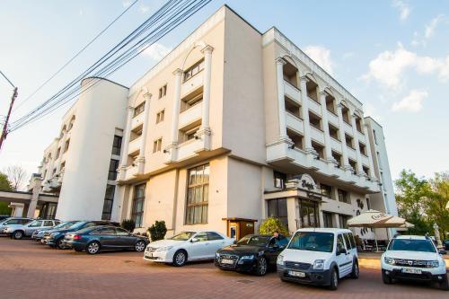 a group of cars parked in front of a building at Hotel Balada in Suceava