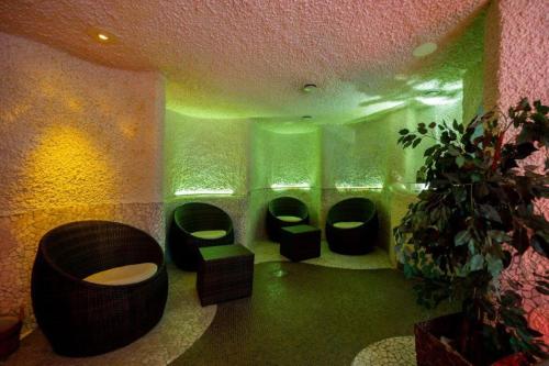 a bathroom with four toilets in a room with green lights at Kronenhotel in Stuttgart