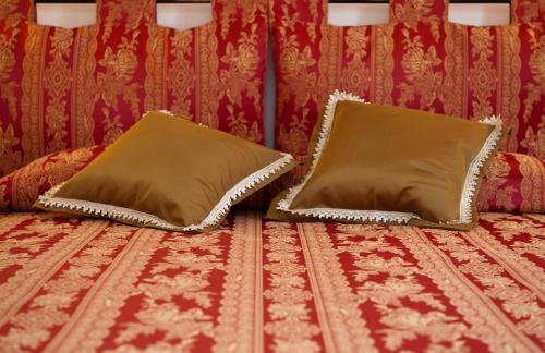 two pillows on a bed with a red wall at Ca Palazzo in Venice