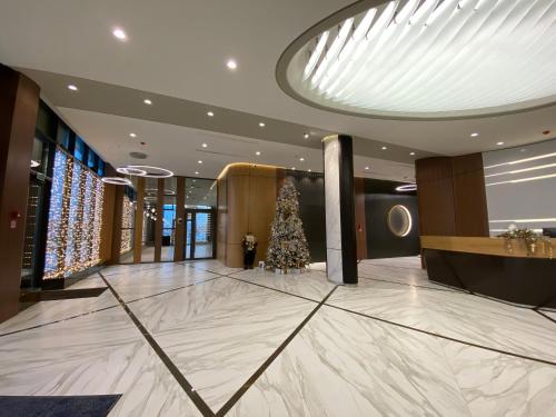 a christmas tree in the lobby of a hotel at Бутик-отель Status in Brest