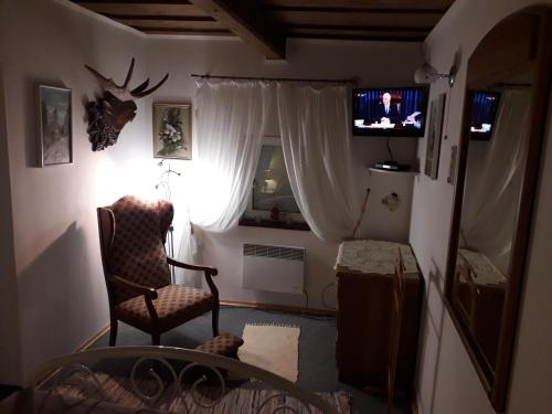 a living room with a chair and a television at Stavne 158 in Stavnoye