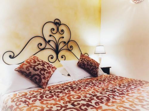 a bedroom with a large bed with pillows on it at Tenuta Pilastru Country Resort & Spa in Arzachena