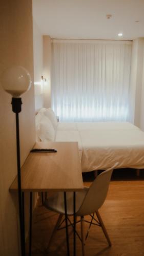 Una cama o camas en una habitación de Pensión Ayala