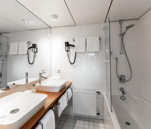a bathroom with a sink and a shower at Hotel Zum Ochsen in Schonwald im Schwarzwald