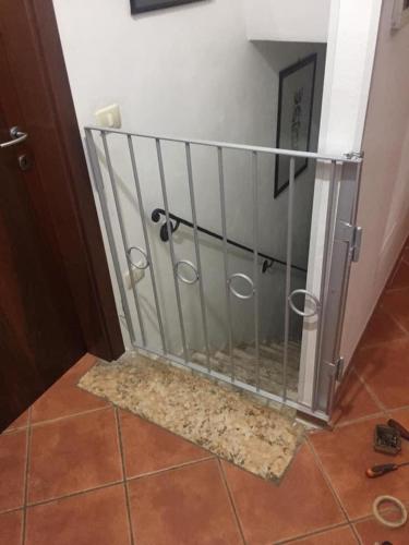 a metal gate in a room with a door at VILLA CLANI apartment in Colà di Lazise