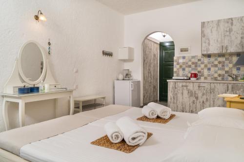 a hotel room with two beds and a bathroom at Villa Plori in Makry Gialos