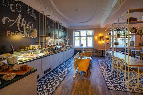 a large kitchen with a table and chairs at Hotel Stadt Cuxhaven in Cuxhaven