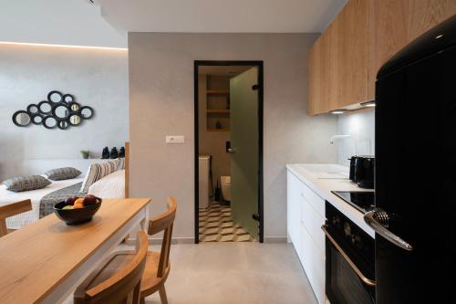 a kitchen with a table and a dining room at Petalo Suites in Rethymno Town