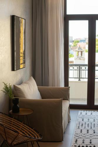 a living room with a couch and a window at Petalo Suites in Rethymno Town