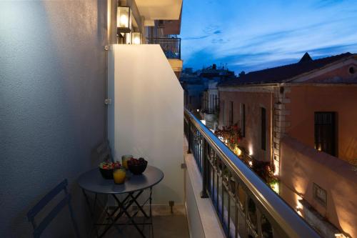 a balcony with a table on the side of a building at Petalo Suites in Rethymno Town