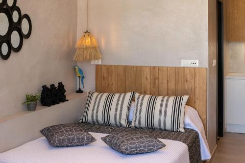 a bedroom with a bed with two pillows on it at Petalo Suites in Rethymno Town