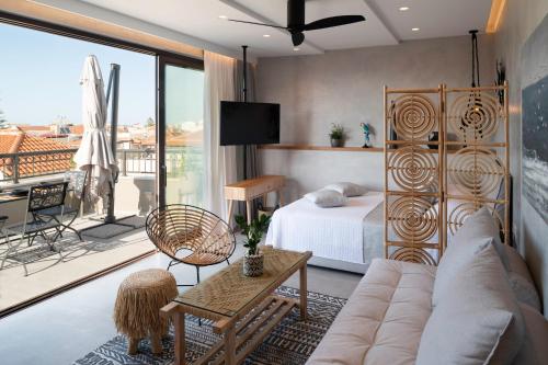 a living room with a bed and a couch at Petalo Suites in Rethymno Town