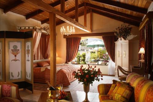 a bedroom with a large bed in a room at La Mirage Garden Hotel & Spa in Cotacachi