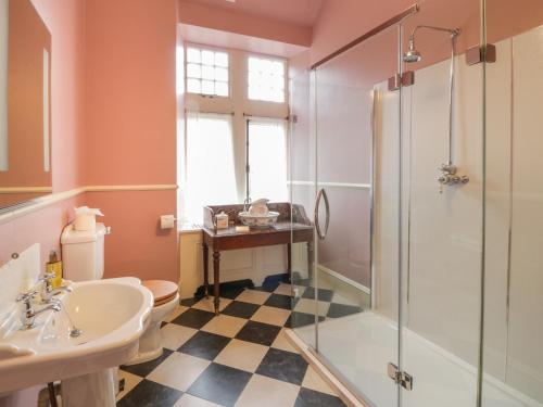 a bathroom with a shower and a toilet and a sink at Bynack - Mar Lodge Estate in Ballater