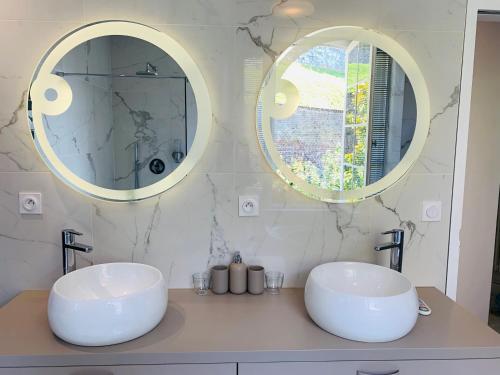 two sinks in a bathroom with two mirrors at Villa Castel Chambres d'hôtes B&B in Dieppe
