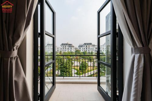a room with a view of a balcony with windows at Merry House Imperia in Hai Phong