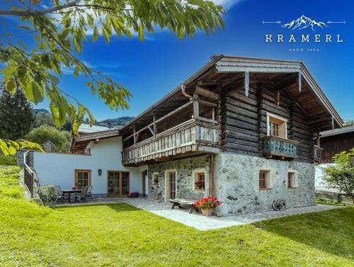 a log house with a porch and a balcony at Kramerl in Bruck an der Großglocknerstraße