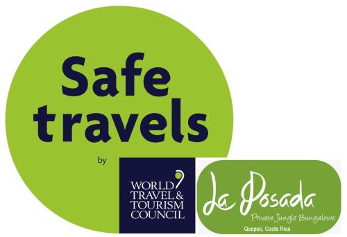 a green circle with the words safe travels on it at La Posada Jungle Hotel in Manuel Antonio