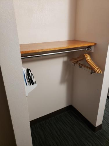 a closet with a wooden shelf on the wall at Holiday Inn Express Richmond-Brandermill-Hull Street by IHG in Brandermill