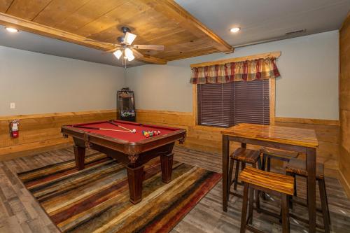 a billiard room with a pool table and two tables at BearVue Point chalet in Gatlinburg