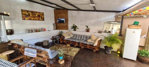 a living room with a couch and a table at Hostel AJBJ Turismo in Curitiba