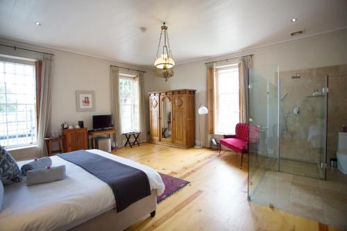 a bedroom with a bed and a glass shower at Beckhuis in Worcester