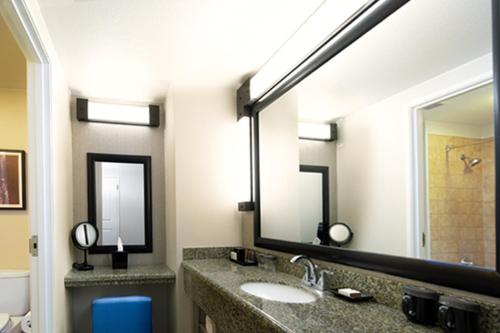 a bathroom with a sink and two mirrors at Chukchansi Gold Resort & Casino in Coarsegold