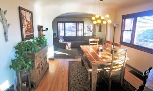 a living room with a wooden table and a couch at 6-Bedroom Tudor in the Downtown Historic District in Salt Lake City