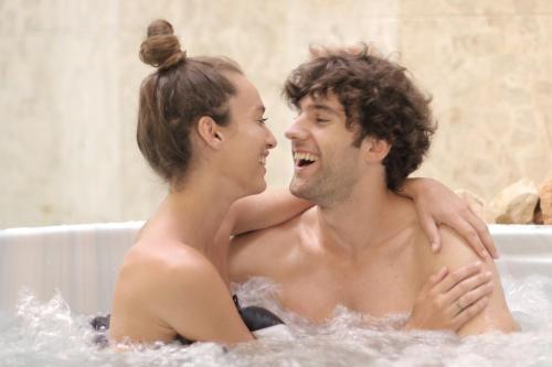 a man and a woman sitting in a bathtub at Pension Fontána Svitavy in Svitavy