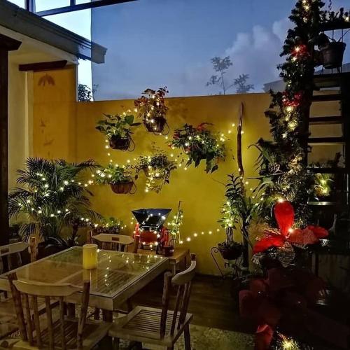 a dining room with a table and christmas decorations at La Estancia Hotel Boutique in Salamina