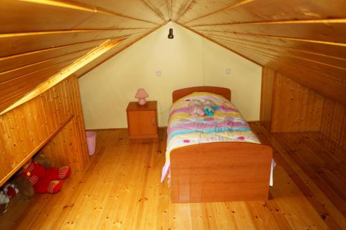 a small bedroom with a bed in a attic at Apartments Julija in Vela Luka