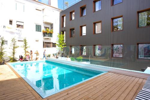 a swimming pool in front of a building at Secret Patio Lisbon in Lisbon