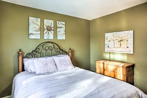 a bedroom with a large bed and two pictures on the wall at Cozy Getaway with Yard and Patio 4 Mi to Hayden Lake! in Hayden