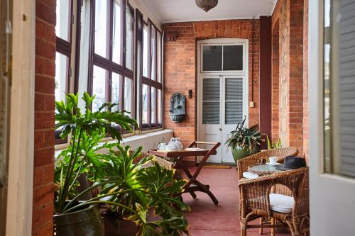 
a living room filled with lots of furniture and plants at Post Office Apartment in York
