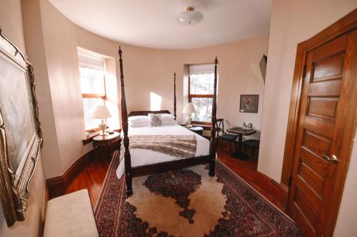 a bedroom with a bed and a wooden door at Bellas Castle in Morden