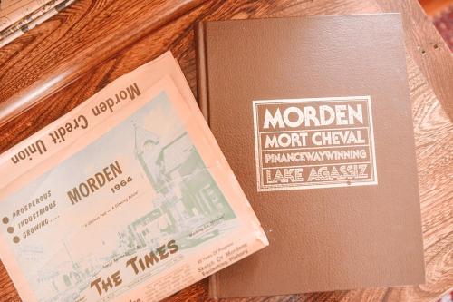 two books sitting on top of a wooden table at Bellas Castle in Morden