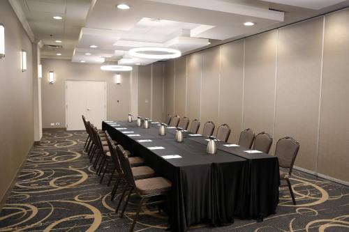 a conference room with a long table and chairs at Holiday Inn O'Hare Area by IHG in Rosemont