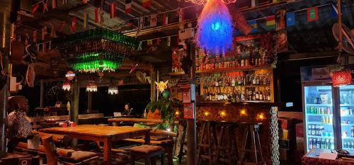 a bar with a wooden table and a bartender at Wooden Hut Koh Kood in Ko Kood