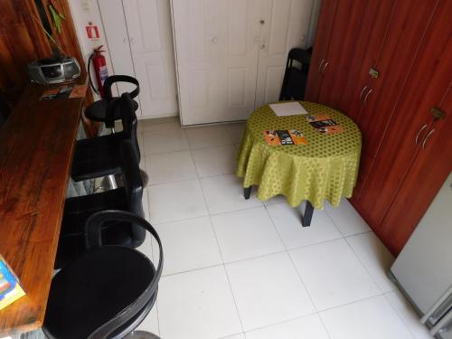 a kitchen with a table and chairs in a kitchen at Hostal Pampaloja Antof in Antofagasta