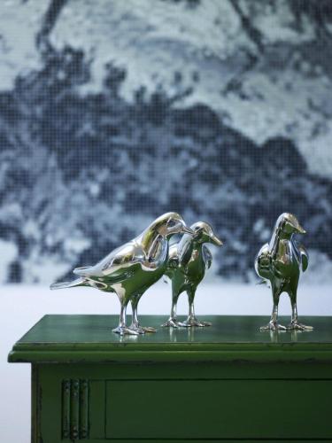 three birds figurines sitting on top of a table at Salvator Villas & Spa Hotel in Parga