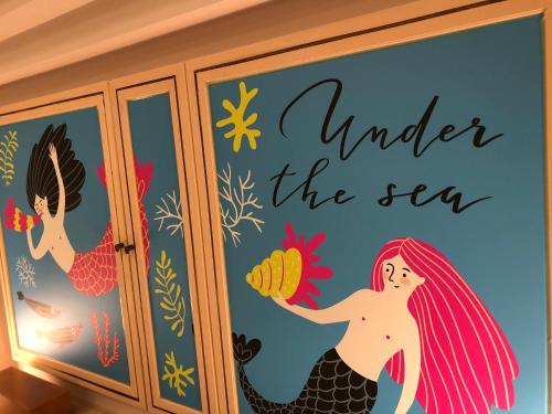 a mermaid under the sea wall mural at Hotel Chapel Sweet (Adult Only) in Kobe