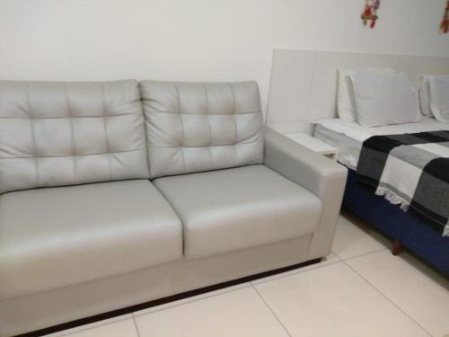 a white couch in a room with a bed at Laguna Beach Flat -205 in Porto De Galinhas