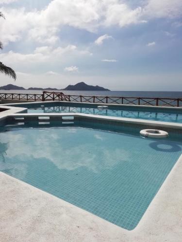 a swimming pool with a view of the ocean at El Encanto Casa Boutique in Manzanillo